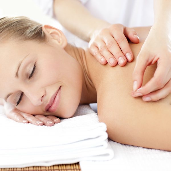 Radiant woman receiving an acupuncture treatment in a health spa